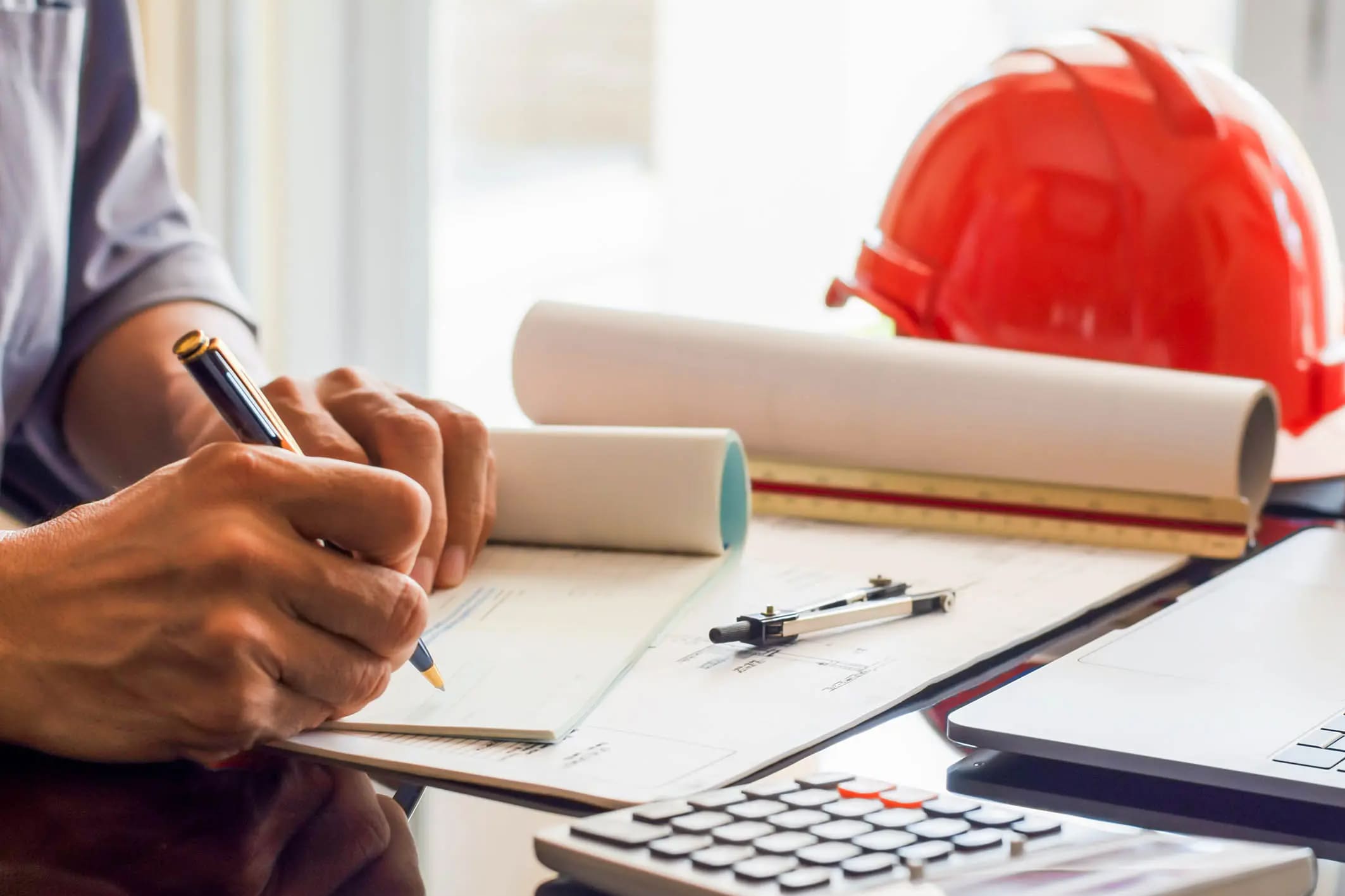 Man writing notes for construction close out