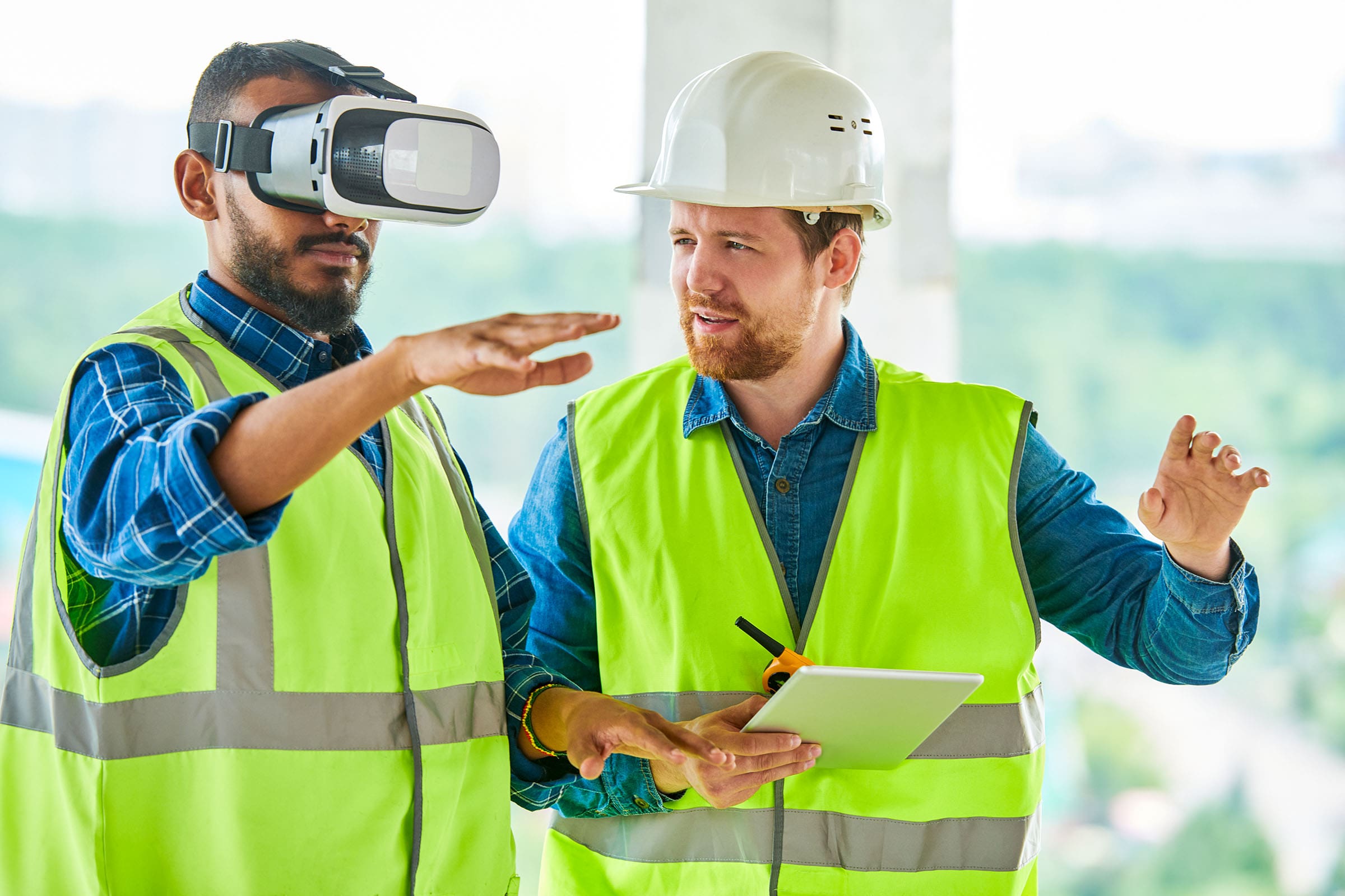 Two workers using VR equipment at jobsite